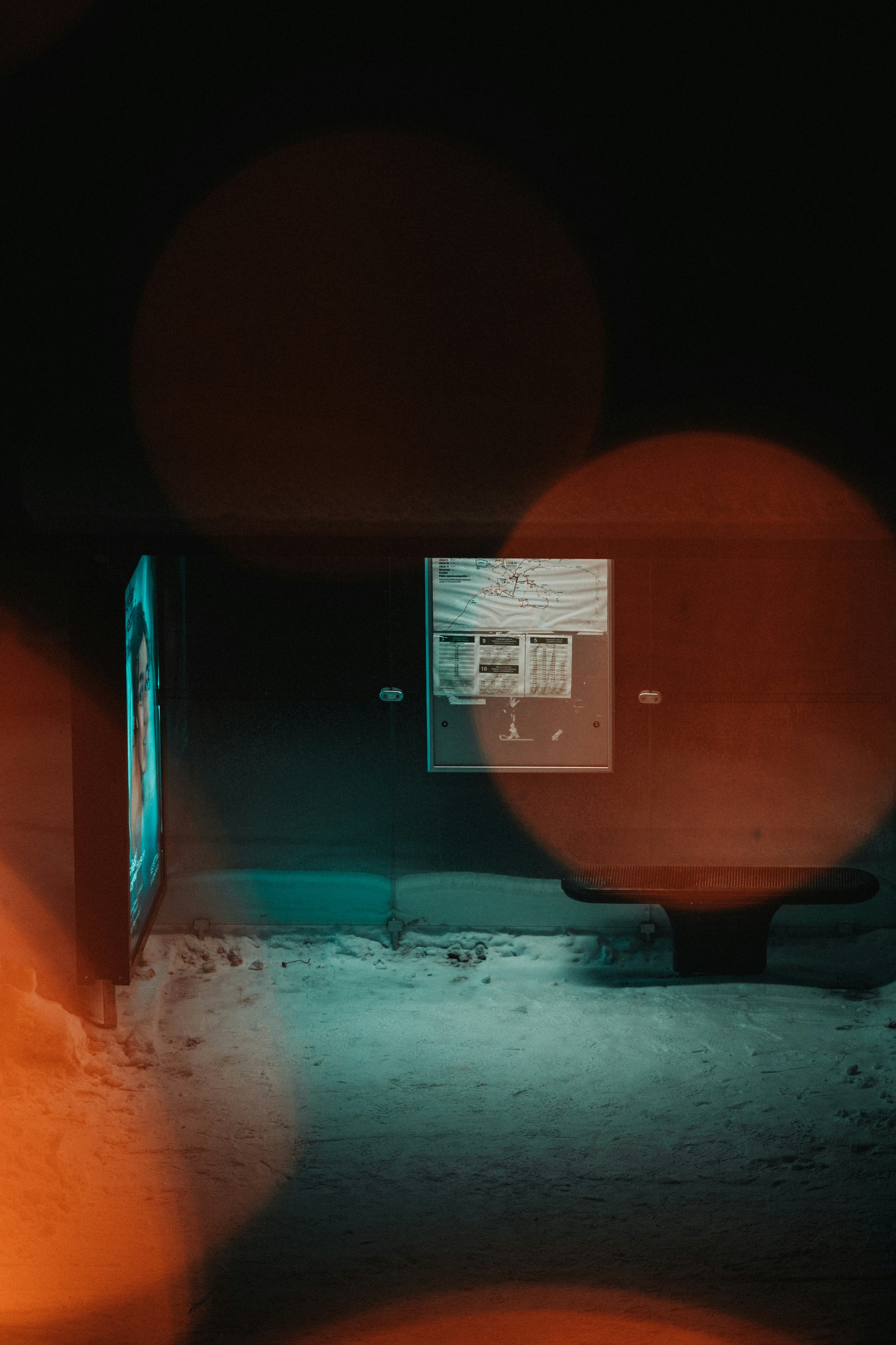 Photographie floue d'un téléviseur allumé diffusant sa lumière dans une pièce plongée dans l'obscurité